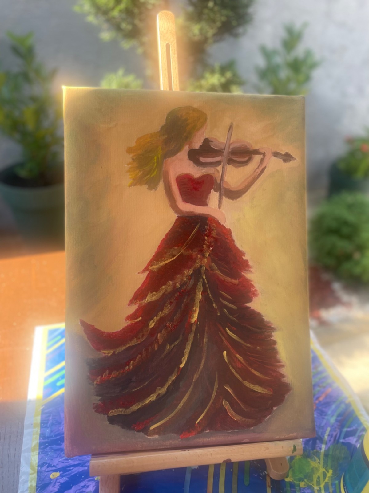 Viola in a red dress with a golden sheen